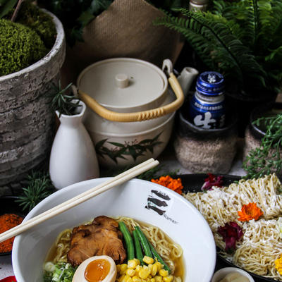 Ramen with egg, steak corn and greens, spices around