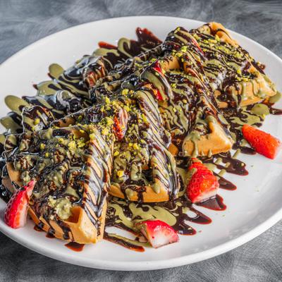 Dubai Chocolate Waffle garnished with sliced strawberries.