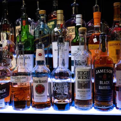 Bottles of hard liquor arranged on shelves.
