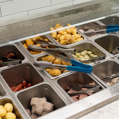Self-serve buffet bar with variety of ingredients.