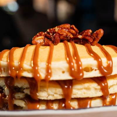 Dulce de Leche Pancakes topped with candied pecans.
