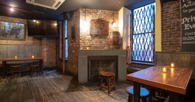 Seating area, tables with candels, barrel on the fireplace