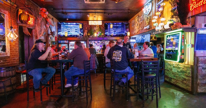 Interior, bar and seating area with neon signs