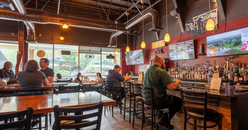 Interior, bar and seating area with guests