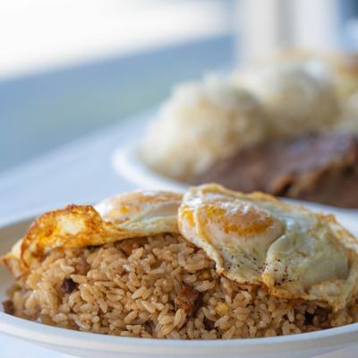Fried rice with two fried eggs on top.