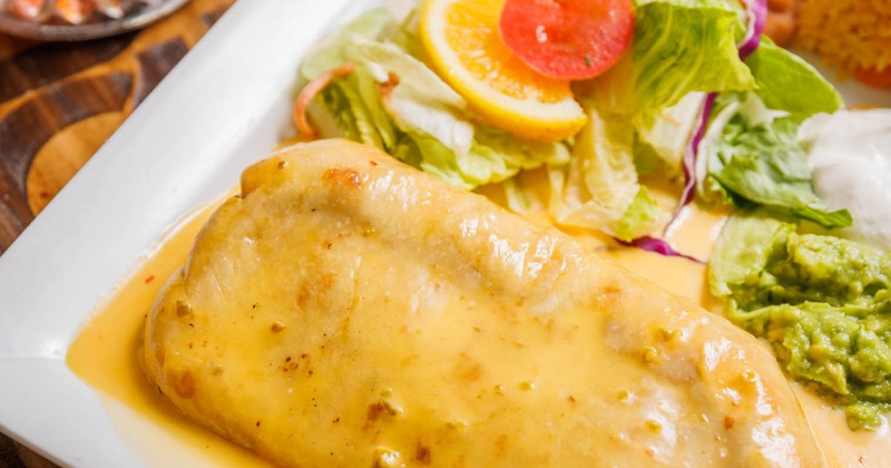 Fried burrito stuffed with a choice of meat, topped with cheese dip