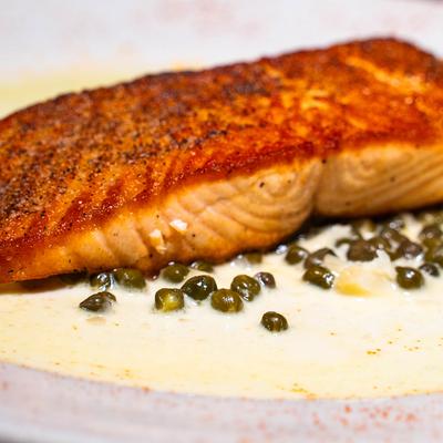 Salmon seared in a lemon caper cream sauce.