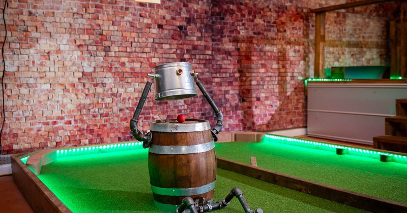 Interior, a humanoid-like barrel on the mini golf course