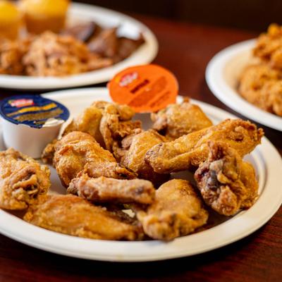 Dozen bone-in wings platter, served, closeup, front view.