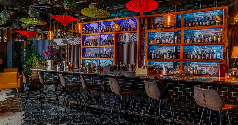 Interior, marble top bar with bar stools, large drink shelves, various detailed decor