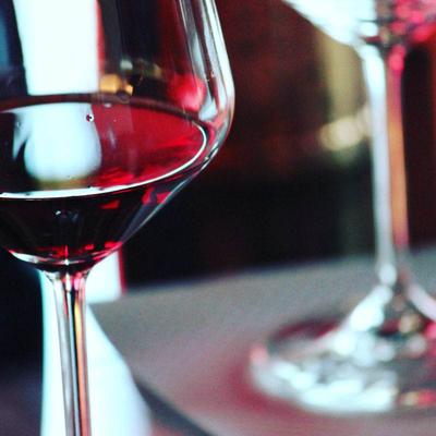 Extreme close up of a glass with red wine.