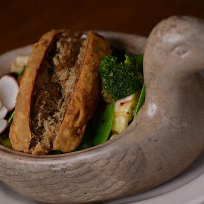 A type of stuffed tofu or similar item, served with broccoli and other vegetables.