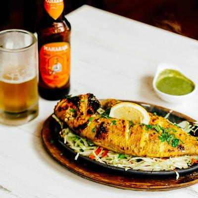 Whole snapper served with beer.