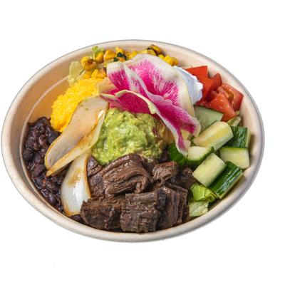 Skirt steak bowl with guacamole, sour creme, rice, beans and fresh vegetables.