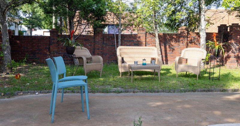 Exterior seating area with armchairs and a coffee table