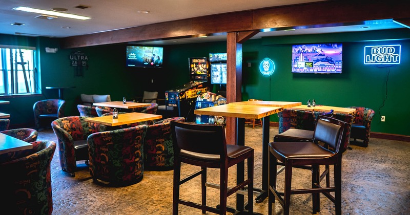 Interior, high chair and table, with wall TV sets