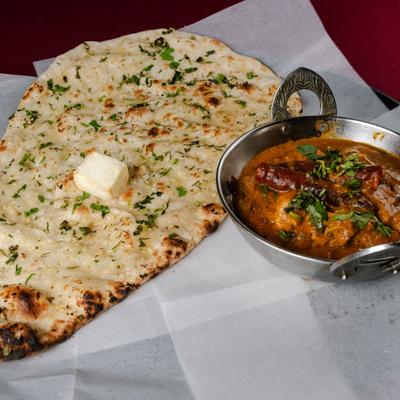 Chicken curry served with naan bread.