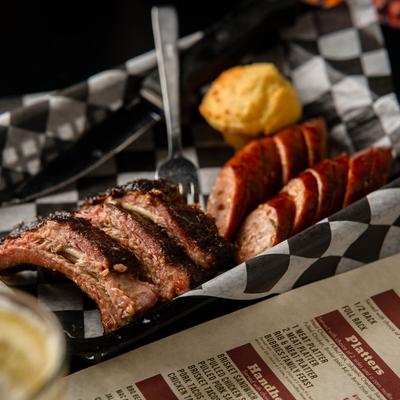 Ribs and sausage with corn muffin.