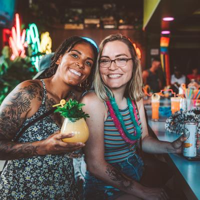 Guests holding drinks and smiling