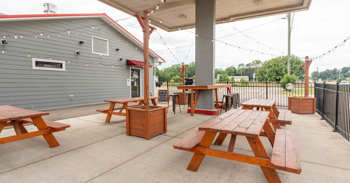 Outdoor dining area with wooden picnic tables