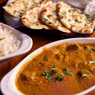 Lamb Curry with sides of rice and garlic naan.