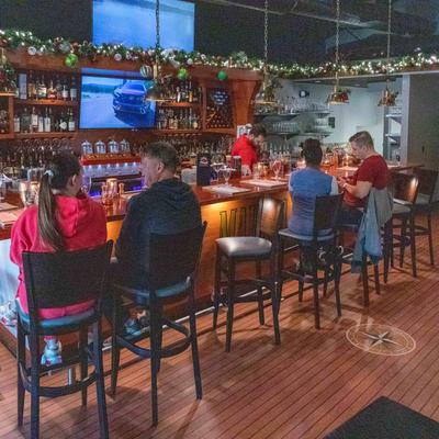 Interior, guests sitting at the bar.