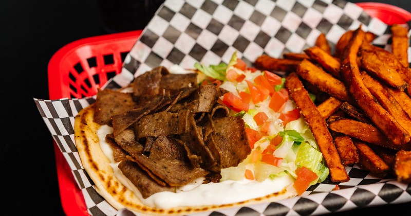 Gyro pita sandwich with sweet potato fries