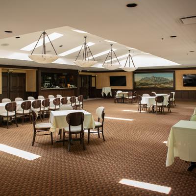 Banquet hall interior featuring unique lighting fixtures and brown carpeting.