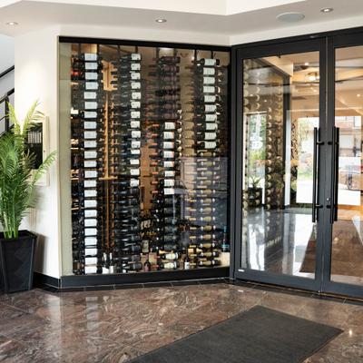 Restaurant dining room entrance featuring glass doors and a glass wine wall display.