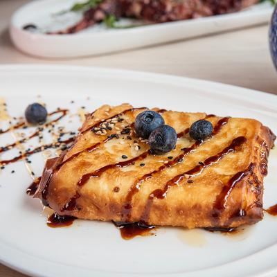 Feta phyllo pastry topped with blueberries and drizzle.
