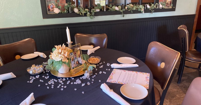 Interior, tables with tableware and chairs, decorative vases filled with corks on the table