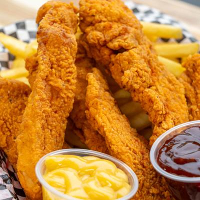 Tenders served with fries and sauces.
