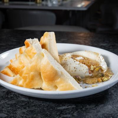 Whipped Ricotta with orange blossom honey, fennel pollen, pistachio and focaccia bread.