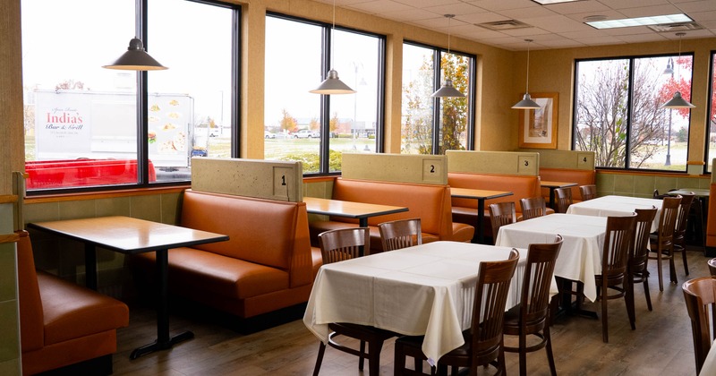 Interior dining area with double booths, chairs and tables