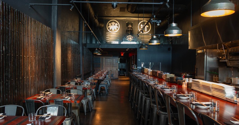 Interior, seating  by the wall side and the bar with bar chairs ready for guests