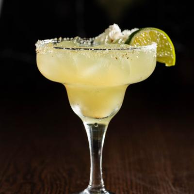 Margarita cocktail with a salted rim and lime garnish.