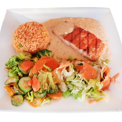 Grilled salmon fillet paired with rice, sautéed vegetables, and a creamy sauce.