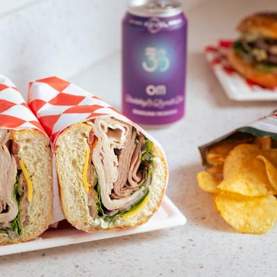 Mama's Special sandwich served with a bag of chips and canned drink.