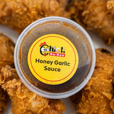 Crispy fried wings surrounding a central cup of Chick Bo-Bao honey garlic sauce.
