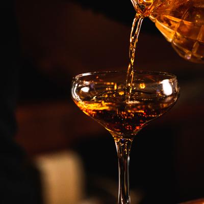 An employee pouring a cocktail