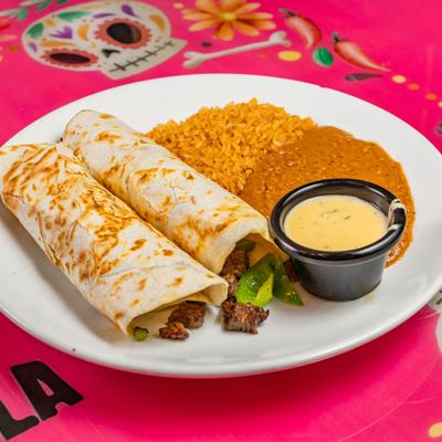 Pork tacos served with rice, beans and dip.