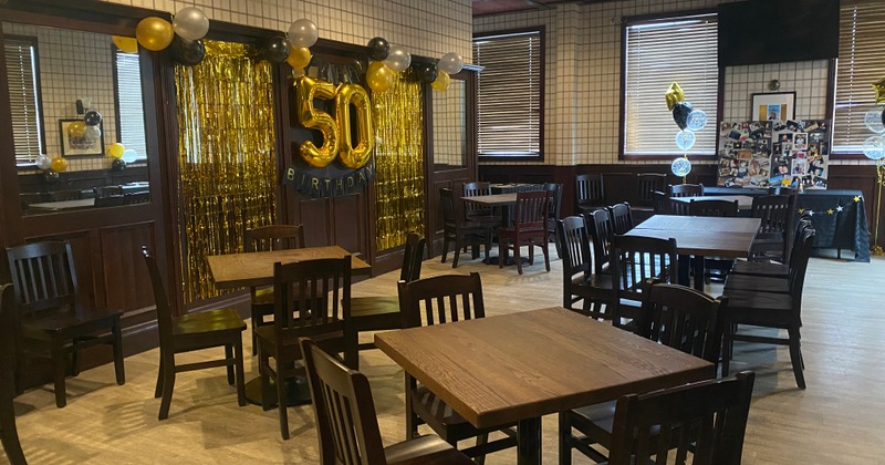 Pub's interior, elegant and spacious bar with a large, U-shaped wooden bar counter in the center