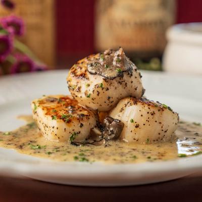 Seared scallops with truffle butter and herbs.