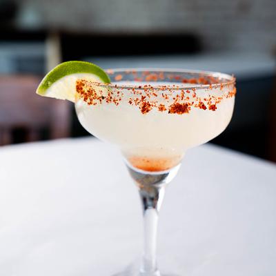 Margarita with tajin rim and lime slice garnish.
