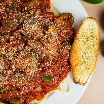 Sausage and peppers in marinara sauce, with garlic bread.