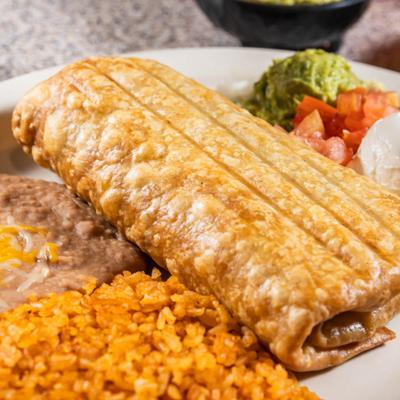 Shredded Beef Chimichanga served with rice, beans, sour creme and guacamole.
