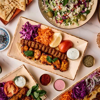 Mixed Grill platter served alongside other dishes, sides and condiments.