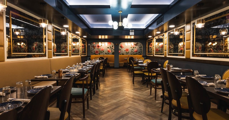Seating area with tables and chairs, mirrors on the walls