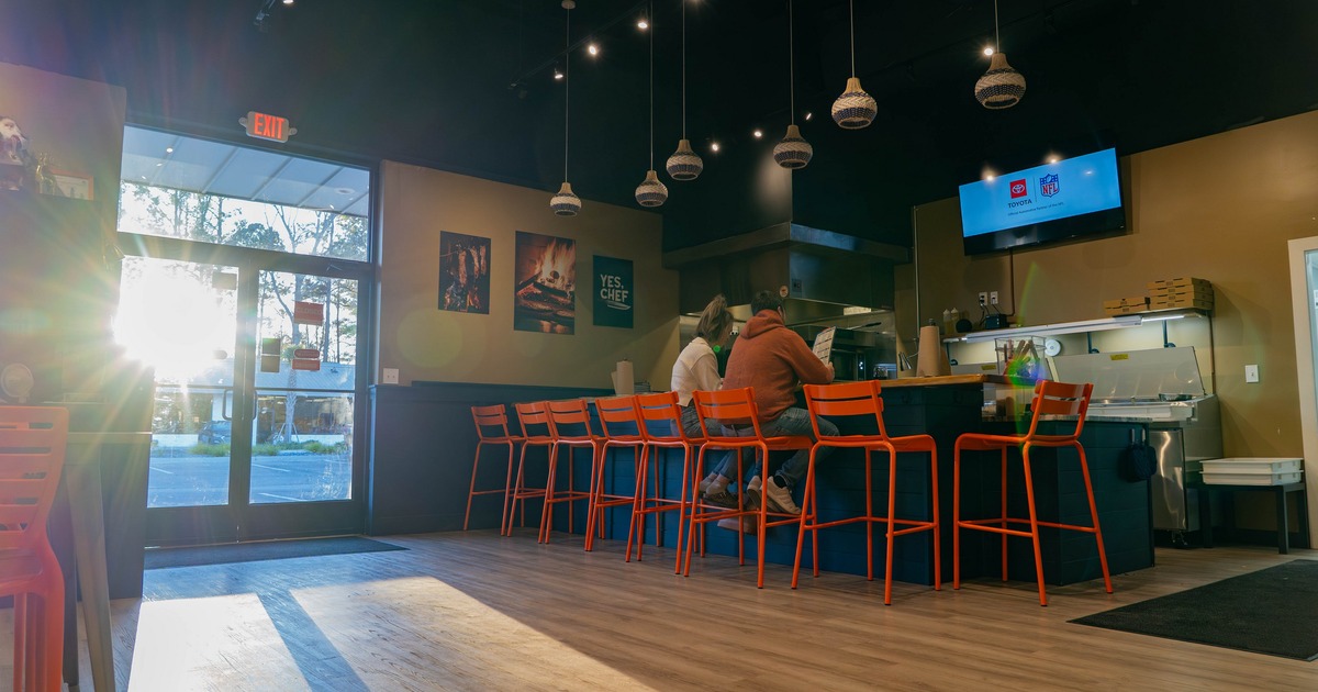 Interior with bright orange stools and a bar