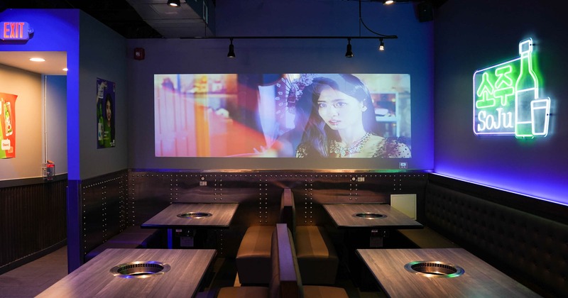 Interior, separated seating area, neon signs, movie projected on the wall